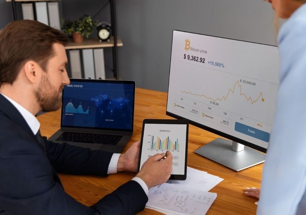 Real estate agents analyzing performance data to see how transaction coordinator software automates and streamlines workflows