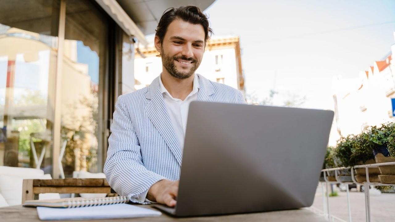 Real estate agent using real estate tracking software to manage deals efficiently