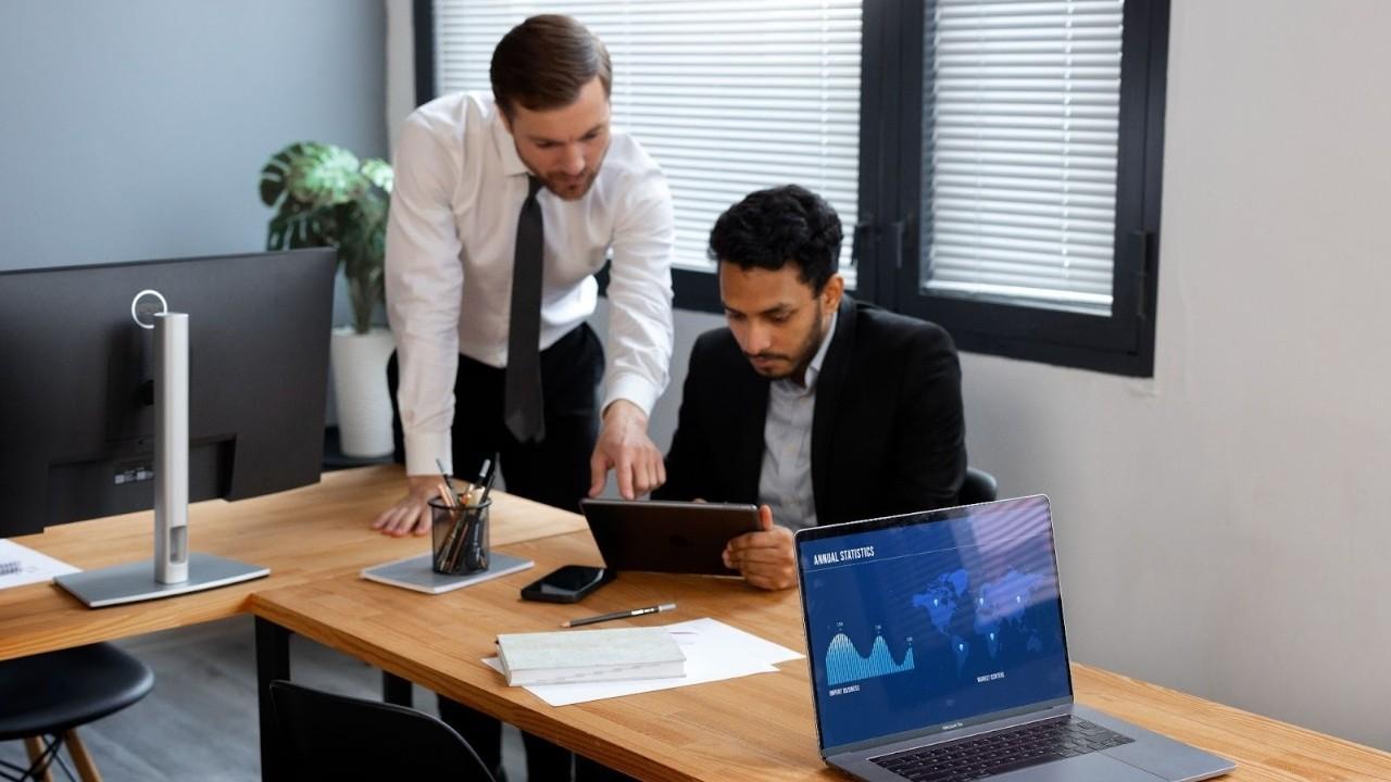 Real estate professional receiving guidance on a tablet, illustrating software support and onboarding